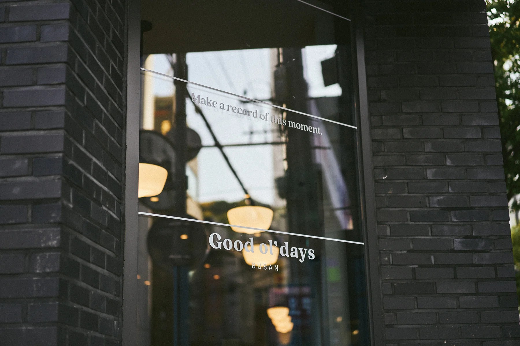 Goodoldays Hotel’s dark-brick exterior, with “Good ol’ days BUSAN” lettering across the window.