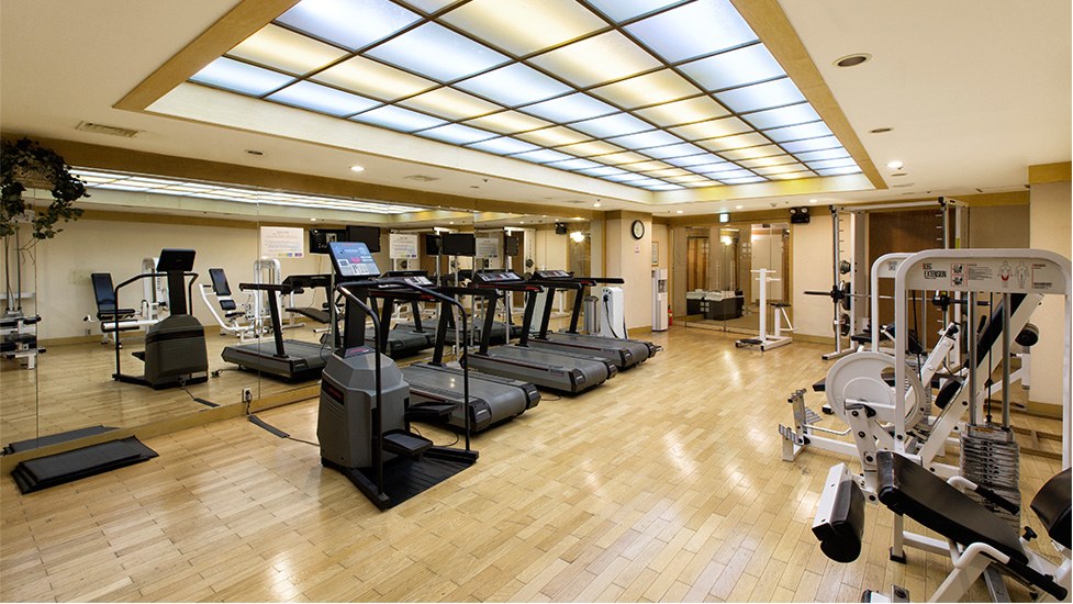 The fitness room at Commodore Hotel Busan, with treadmills and resistance-training equipment.