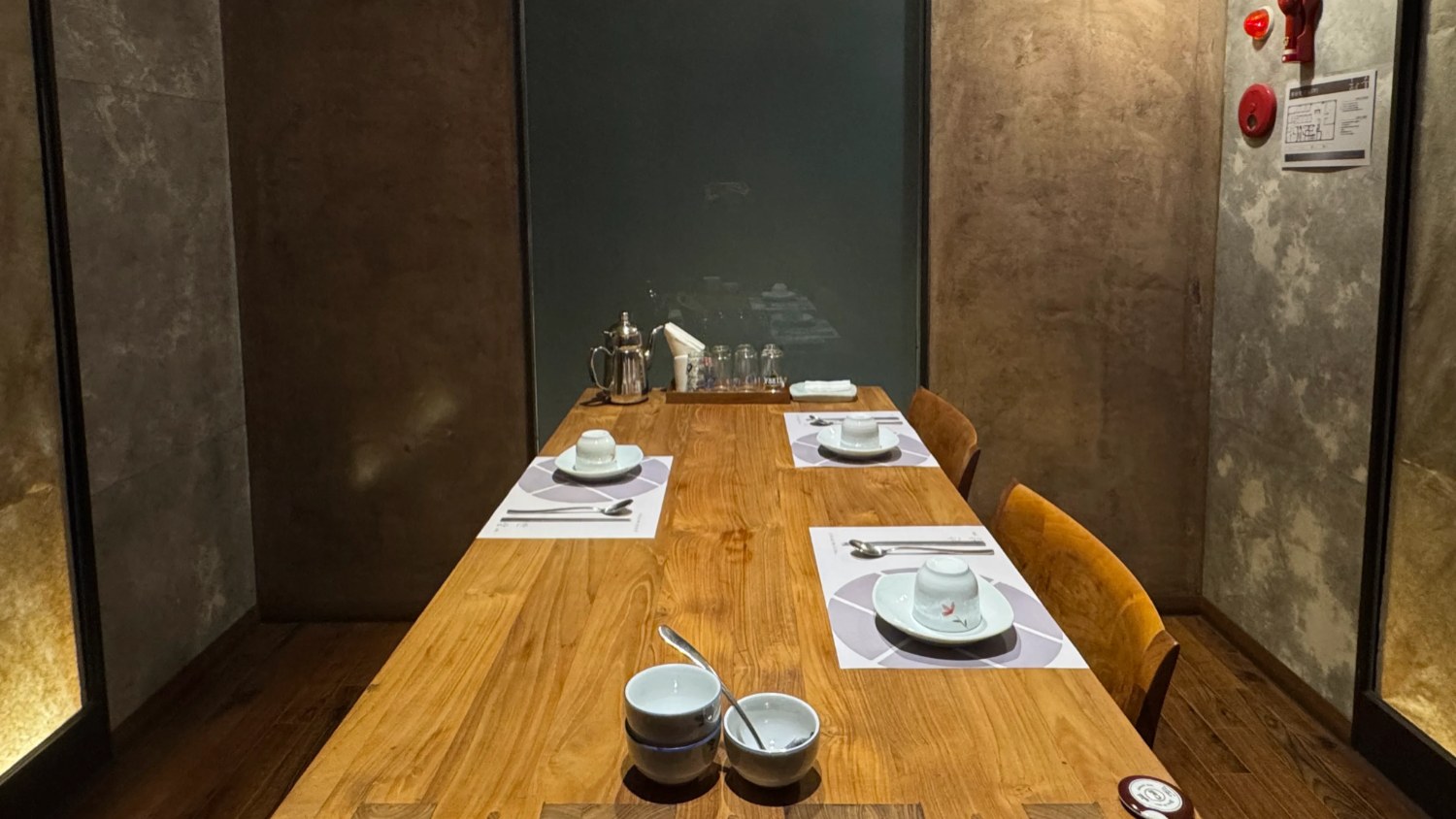 A private dining room at Lascos Bansang Gwangalli with a wooden table and four place settings.