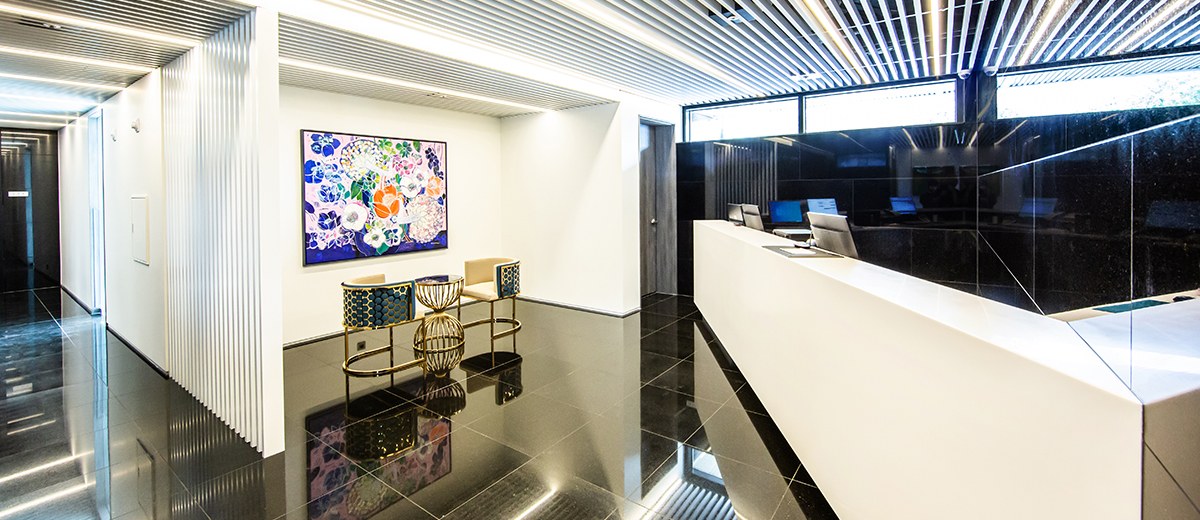 The AG405 Hotel lobby with black tilework and a long white reception desk.