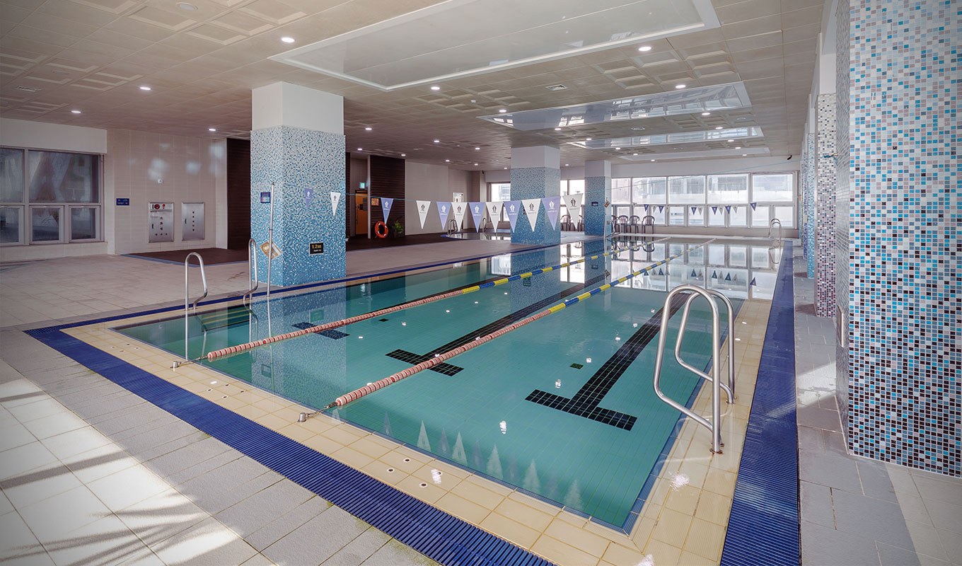 The indoor pool shown on Paledecz Condominium’s official site, with swimming lanes and tiled columns visible.