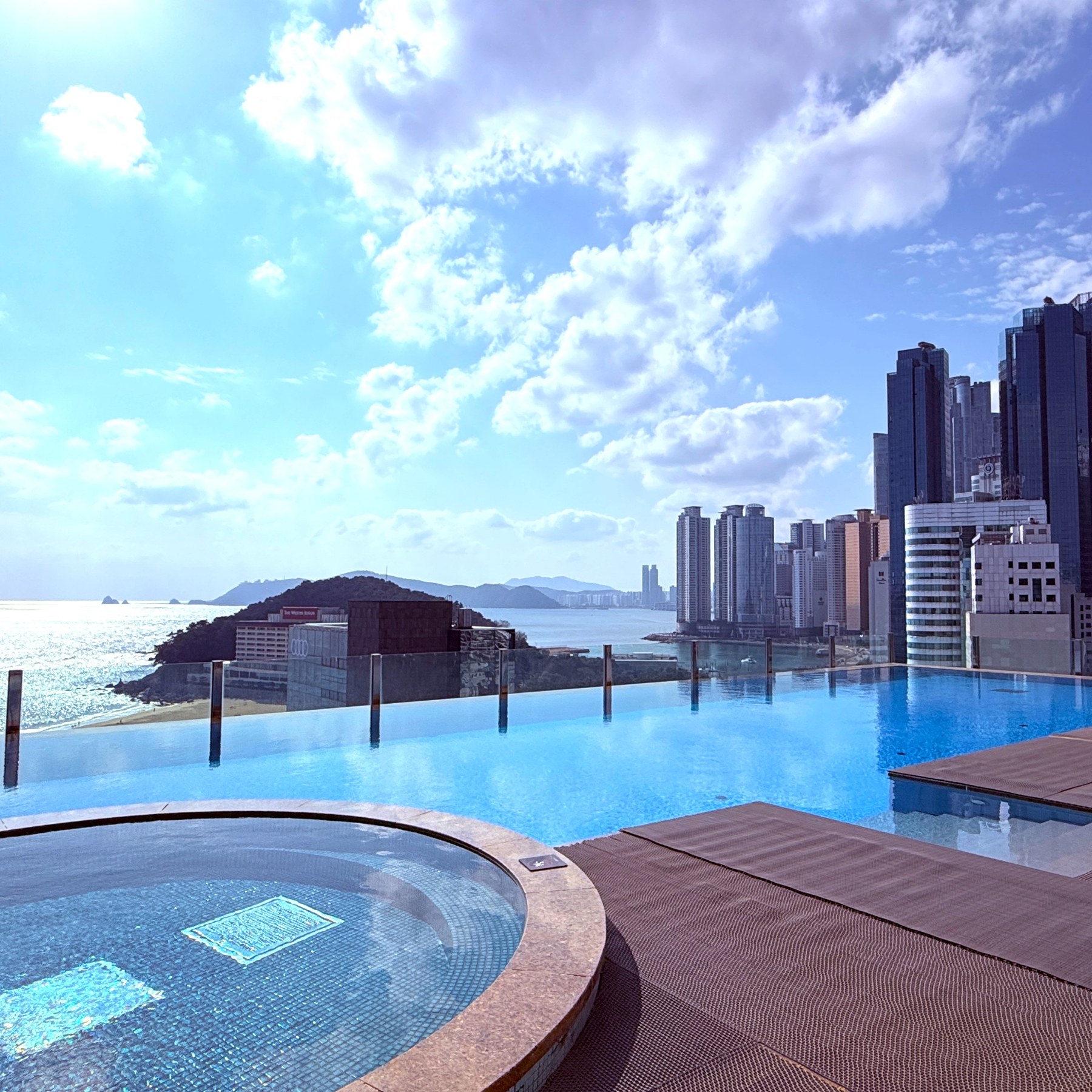 Baymond Hotel’s rooftop pool and circular jacuzzi, overlooking the sea and Haeundae skyline.